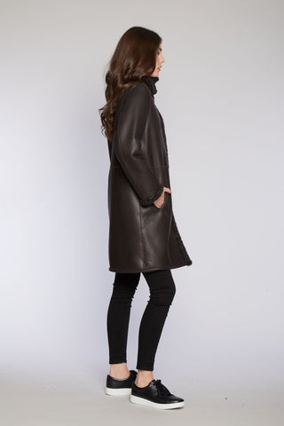 Side View of REVERSIBLE SHEARLING COAT REVERSES TO SOFT NAPPA SHEARLING in Brown with Stand Collar