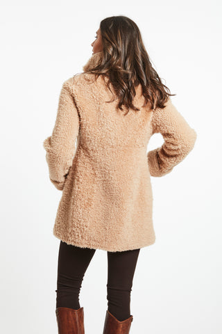 Back View of REVERSIBLE CURLY SHEARLING TOPPER in Beige with Model shot