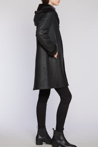 Side View of Hooded Reversible Shearling Coat Shown In Granite Nappa with Cozy hood